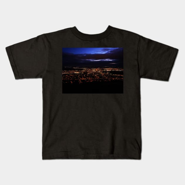 View of city lights from mountain top Kids T-Shirt by Kate-P-
